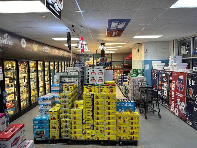 The front room at Rugers Beer in Levittown, with a floor display of beer cases and coolers along the wall