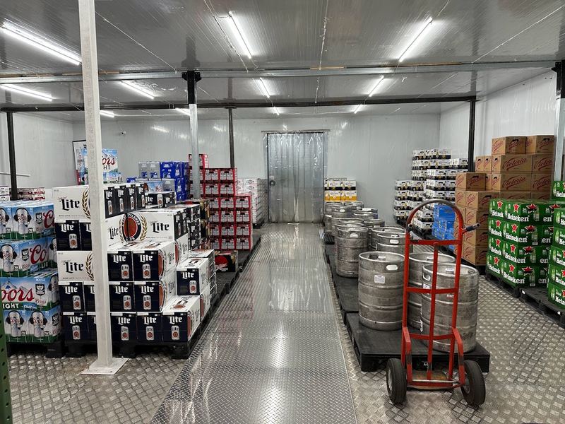 Walk-in cooler at Rugers Beer in Levittown, with kegs and cases of beer